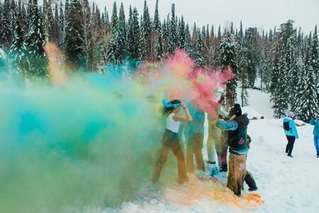 Sheregesh, Kemerovo region, Russia - April 06, 2019: Grelka Fest is a sports and entertainment activity for ski and snowboard riders in bikini. A group of a young people throwing colorful holi powder.のeditorial素材
