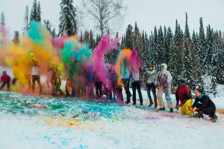 Sheregesh, Kemerovo region, Russia - April 06, 2019: Grelka Fest is a sports and entertainment activity for ski and snowboard riders in bikini. A group of a young people throwing colorful holi powder.のeditorial素材