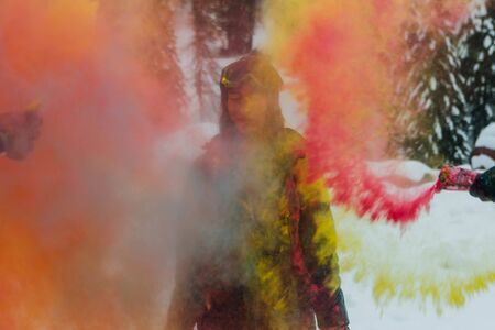 Sheregesh, Kemerovo region, Russia - April 06, 2019: Grelka Fest is a sports and entertainment activity for ski and snowboard riders in bikini. Young happy woman painted with Holi colorsのeditorial素材