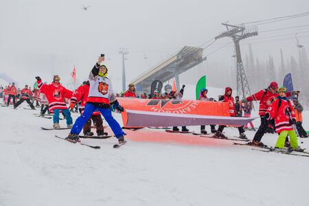 Sheregesh, Kemerovo region, Russia - April 06, 2019: Grelka Fest is a sports and entertainment activity for ski and snowboard riders. Young people in hockey team Metallurg t-shirts on a mountain slopeのeditorial素材