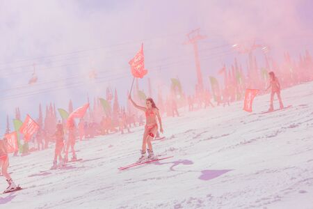 Sheregesh, Kemerovo region, Russia - April 13, 2019: Grelka Fest is a sports and entertainment activity for ski and snowboard riders in bikini in Russia, Sheregesh. Woman in bikini on mountain skiのeditorial素材