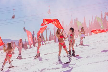 Sheregesh, Kemerovo region, Russia - April 13, 2019: Grelka Fest is a sports and entertainment activity for ski and snowboard riders in bikini in Russia, Sheregesh. Woman in bikini on mountain skiのeditorial素材