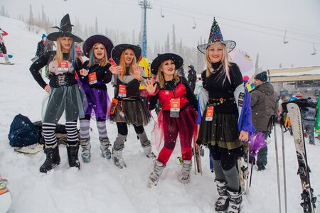Sheregesh, Kemerovo region, Russia - April 06, 2019: Grelka Fest is a sports and entertainment activity for ski and snowboard riders in carnival costume. Young women in carnival costumes of witches.のeditorial素材