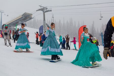 Sheregesh, Kemerovo region, Russia - April 06, 2019: Grelka Fest is a sports and entertainment activity for ski and snowboard riders in carnival costume. Young people in carnival costumes.のeditorial素材