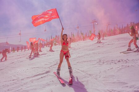 Sheregesh, Kemerovo region, Russia - April 13, 2019: Grelka Fest is a sports and entertainment activity for ski and snowboard riders in bikini in Russia, Sheregesh. Woman in bikini on mountain skiのeditorial素材