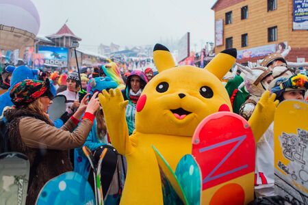 Sheregesh, Kemerovo region, Russia - April 06, 2019: Young people in carnival costumes on the mountain slope.のeditorial素材