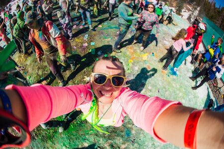 Sheregesh, Kemerovo region, Russia - April 13, 2019: Woman with green hair takes selfie on Holi festivalのeditorial素材