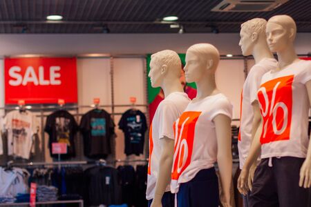 Manikens with sale sign in a shop. Sale in a shopping mallの写真素材