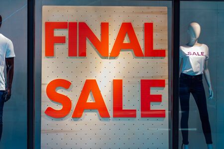 Storefronts with sale sign behind the glass window in shopping mallの写真素材
