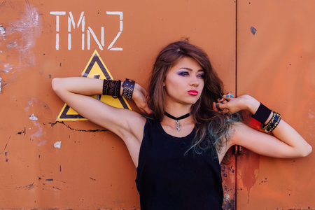 Young beautiful rock and roll girl with bright colorful makeupの写真素材