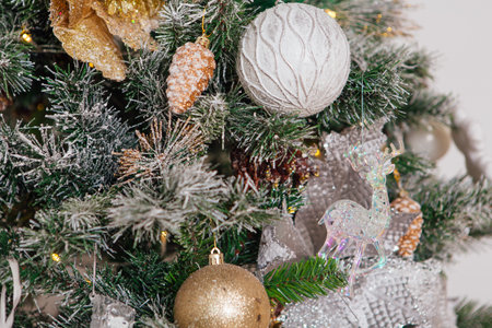 Christmas tree decorated with balls and other decorations close up