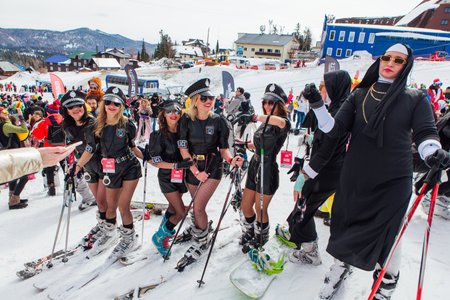Sheregesh, Kemerovo region, Russia - April 03, 2021: Grelka Fest is a sports and entertainment activity for ski and snowboard riders in carnival costume. People in carnival costumes riding ski and snowboard.のeditorial素材