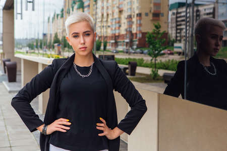 Young stylish business woman with short hair and nose piercing. Confident girl look like lesbian...