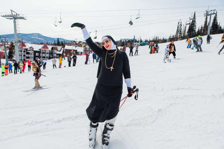 Sheregesh, Kemerovo region, Russia - April 03, 2021: Grelka Fest is a sports and entertainment activity for ski and snowboard riders. People in carnival costumes riding ski and snowboard.のeditorial素材