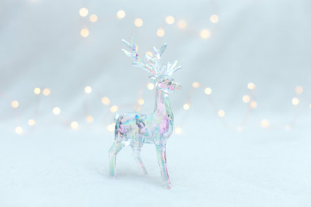 Statuette of a transparent plastic deer with backlight on a white background. Christmas decoration.の写真素材