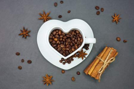Roasted Coffee beans in heart shape cup.の写真素材
