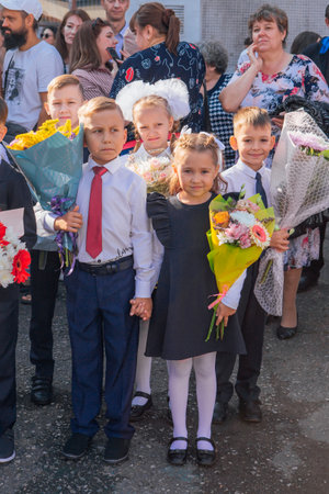 Meeting with the first-grade pupils and teacher at schoolyard. The day of knowledge in Russia.のeditorial素材