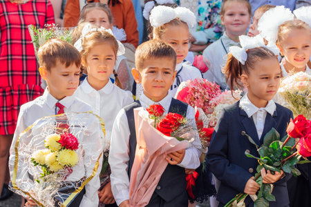Meeting with the first-grade pupils and teacher at schoolyard. The day of knowledge in Russia.のeditorial素材
