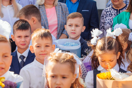 Meeting with the first-grade pupils and teacher at schoolyard. The day of knowledge in Russia.のeditorial素材
