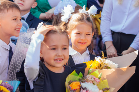 Meeting with the first-grade pupils and teacher at schoolyard. The day of knowledge in Russia.のeditorial素材