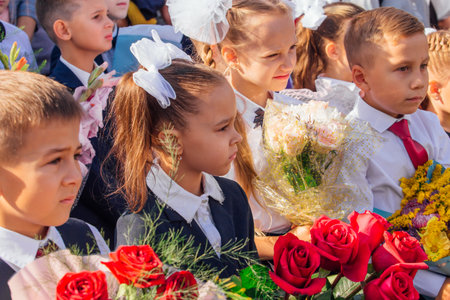 Meeting with the first-grade pupils and teacher at schoolyard. The day of knowledge in Russia.のeditorial素材