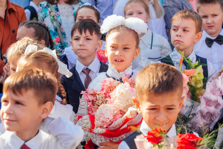 Meeting with the first-grade pupils and teacher at schoolyard. The day of knowledge in Russia.のeditorial素材