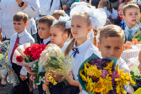 Meeting with the first-grade pupils and teacher at schoolyard. The day of knowledge in Russia.のeditorial素材