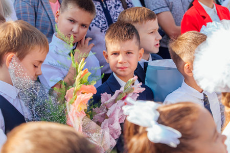 Meeting with the first-grade pupils and teacher at schoolyard. The day of knowledge in Russia.のeditorial素材