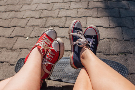 Red and blue sneakers shoes on a feet. Sneakers shoes Couple. Copy space.の写真素材