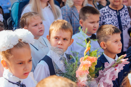 Meeting with the first-grade pupils and teacher at schoolyard. The day of knowledge in Russia.のeditorial素材