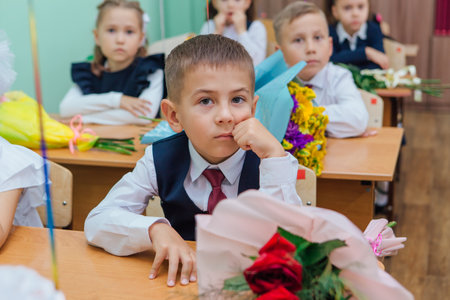 First-grade students and teacher are in school classroom at first lesson. The day of knowledge in Russia.のeditorial素材