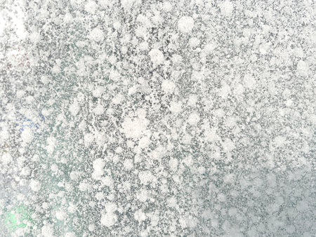 Ice texture background. Textured cold frosty surface of ice block with frozen air bubbles.の写真素材