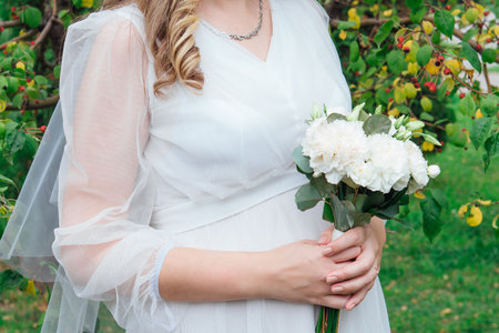 Bride holding a beautiful white wedding bouquet.の写真素材