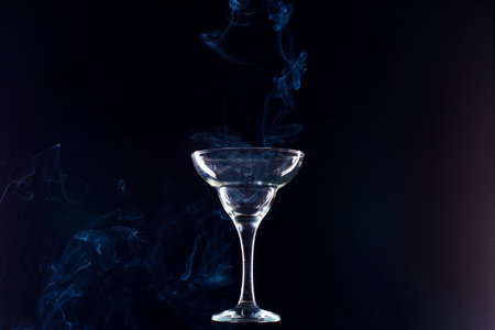 levitating glass full of smoke on a black backgroundの写真素材