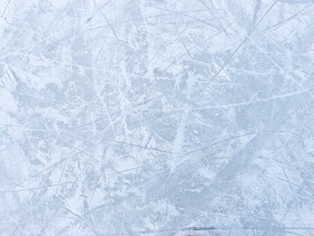 Ice background with marks from skating and hockey. Ice hockey rink scratches surfaceの写真素材