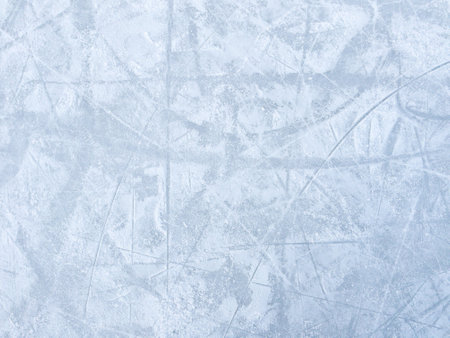 Ice background with marks from skating and hockey. Ice hockey rink scratches surfaceの写真素材