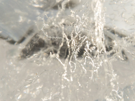 Ice texture background. Textured cold frosty surface of ice block with frozen air bubbles.の写真素材