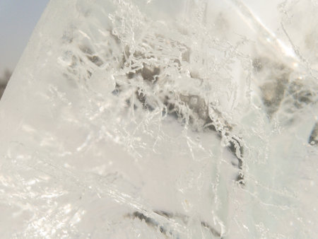 Ice texture background. Textured cold frosty surface of ice block with frozen air bubbles.の写真素材