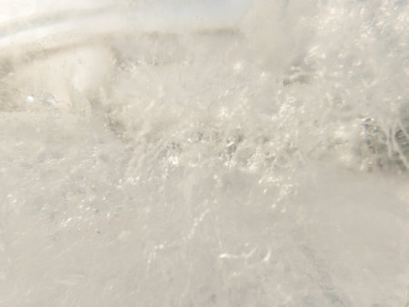 Ice texture background. Textured cold frosty surface of ice block with frozen air bubbles.の写真素材
