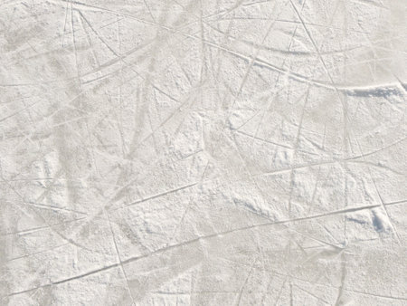 Ice background with marks from skating and hockey. Ice hockey rink scratches surfaceの写真素材