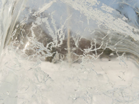 Ice texture background close up. Textured cold frosty surface of ice block with frozen air bubbles.