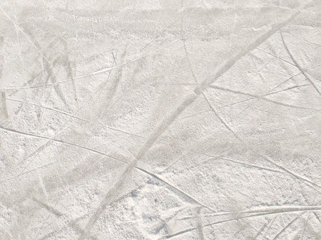 Ice background with marks from skating and hockey. Ice hockey rink scratches surfaceの写真素材