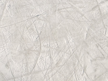 Ice background with marks from skating and hockey. Ice hockey rink scratches surfaceの写真素材