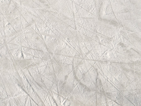 Ice background with marks from skating and hockey. Ice hockey rink scratches surfaceの写真素材