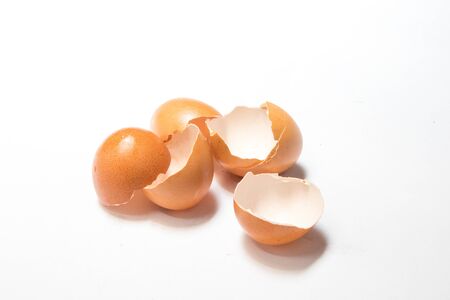 Broken eggshell on white background with shadowの写真素材
