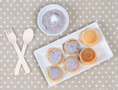 Mini pancake topped stirred taro on gray.の写真素材