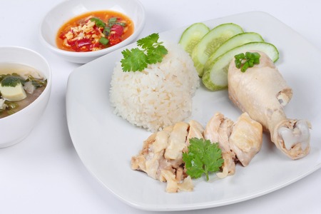 Streamed oily rice and streamed chicken as "Hainanese chicken rice" served with spicy soy bean sauce on white background.の写真素材
