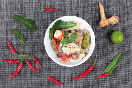 Chicken and galangal in coconut milk soup and herb . Top view