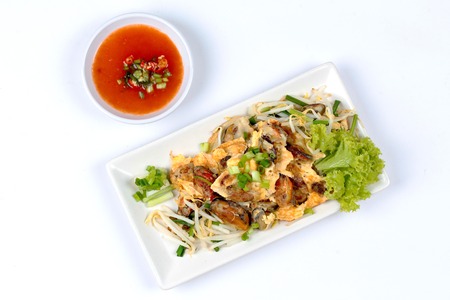 Fried oyster with bean sprouts and shallot as "Hoi Tod" in Thai served with chili sauce.Top Viewの写真素材