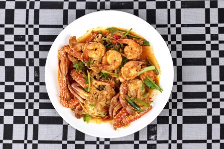 Stir-fried crab and shrimp in curry power is top-ten of popular Thai food as seafood to fried with  fresh milk ,grill curry ,egg ,oyster oil and yellow curry power.の写真素材
